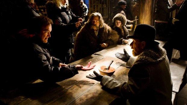 Quentin Tarantino on the set of <i>The Hateful Eight</i>, with cast members including Kurt Russell, centre, and Tim Roth, right.