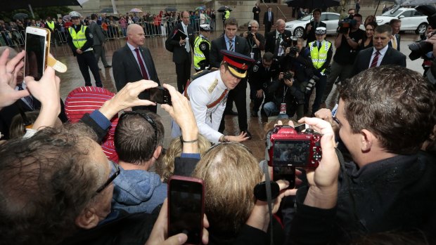  Prince Harry meets the crowd who braved wet weather outside the Australian War Memorial.