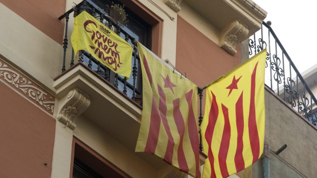 Pro-independent Catalonia flags hang from the balcony of a home in Barcelona on Monday. 