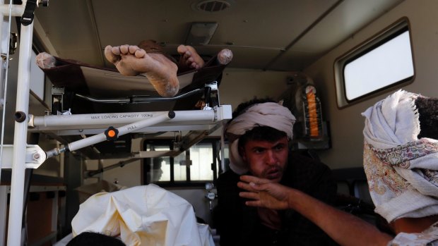Bodies of victims of a Saudi-led coalition airstrike are loaded into an ambulance.