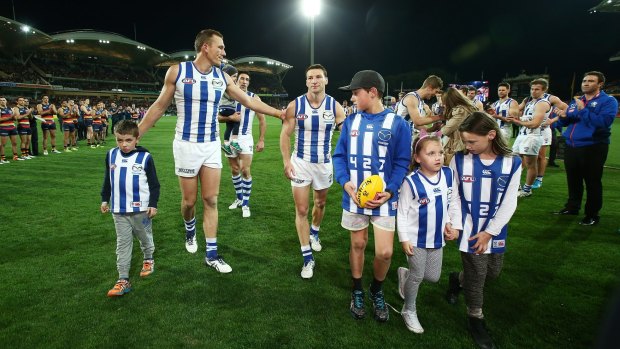 Over and outed: Kangaroos players Drew Petrie and Brent Harvey leave the ground after the loss to Adelaide on Saturday. 