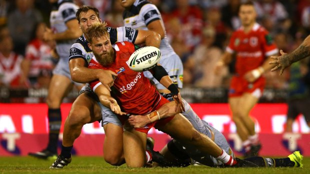 Pass mark: Jack de Belin offloads against the Cowboys. The Dragons have the highest number of offloads in 2017.