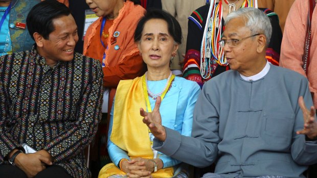 Myanmar's President Htin Kyaw, right, speaks to State Counsellor Aung San Suu Kyi, centre, and Myanmar's Vice President Henry Van Hti Yu at the second session of the 21st Century Panglong Union Peace Conference last week.