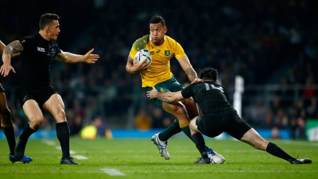 On the move: Israel Folau runs into the All Blacks defence in the World Cup final.