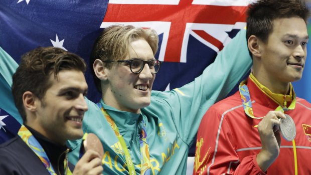 Mack Horton, centre, celebrates after beating Sun Yang, right. in the the men's 400m freestyle.