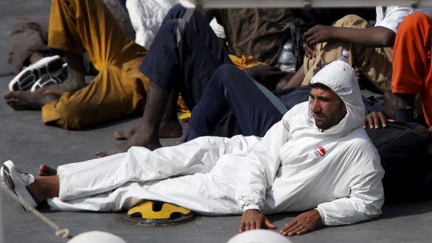 Mohammed Ali Malek, captain of a boat carrying migrants that capsized in the Mediterranean, watches as bodies are brought to land. He was later arrested. 