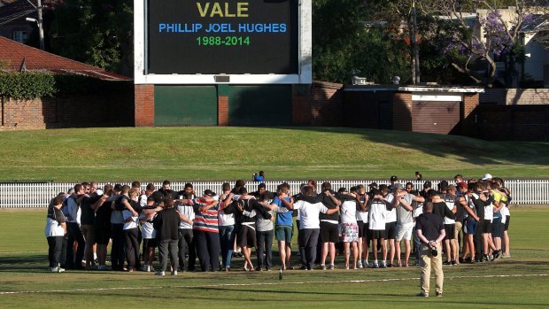 Sombre: Western Suburbs cricket club pause to remember one of their own on Friday evening.