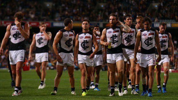 Beaten again: Carlton players leave the field after a hammering in Perth.