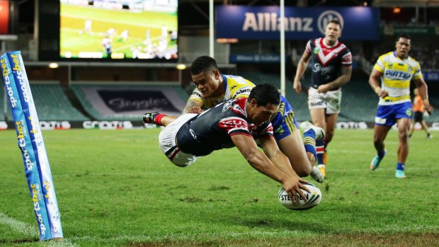 Touchdown: Roger Tuivasa-Sheck dives over to score a try in the corner.
