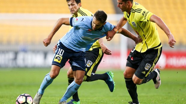 Star turn: Milos Ninkovic holds off the challenge of Marco Rossi.