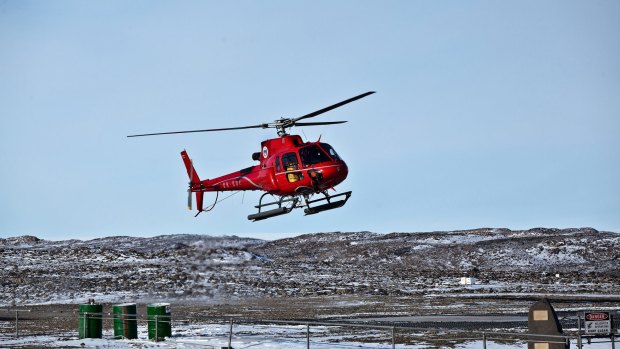 A helicopter pilot has been rescued after he fell down a crevasse on an ice sheet.