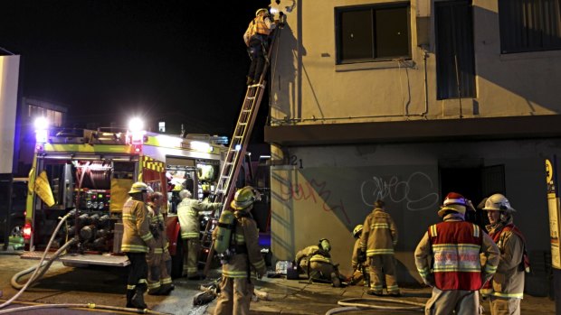 Firefighters attend a fire in a hostel on Parramatta Road