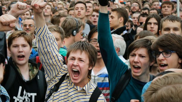 Young protesters  are blocked by riot police during a demonstration in downtown Moscow.