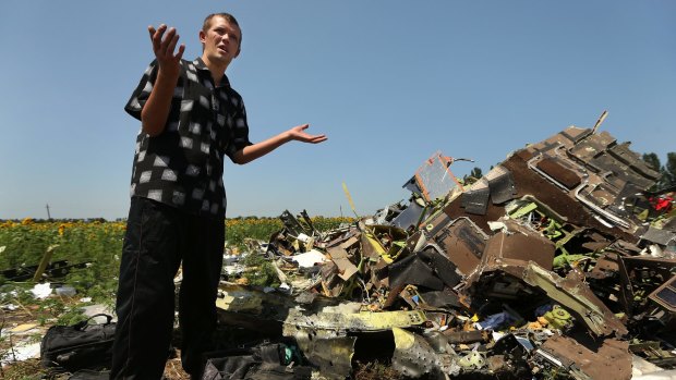 Eugene Lukovkin by the wreckage near the site where he witnessed Malaysian flight MH17 crashing in Ukraine in July, 2014.