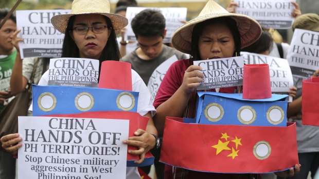 Filipino student activists hold mock Chinese ships to protest China's recent island-building and alleged militarisation of the disputed Spratly Islands.