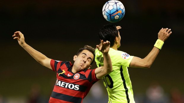Walloping: Steve Lustica of the Wanderers contests the ball against Ryota Moriwaki of Urawa Red Diamonds at Campbelltown Sports Stadium on Tuesday.