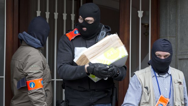 Belgian police leave after an investigation in a house in Brussels.