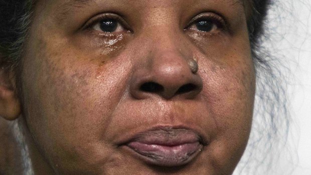 Esaw Garner, widow of Eric Garner, cries as civil rights activist Reverend Al Sharpton spoke about the case in late November. 