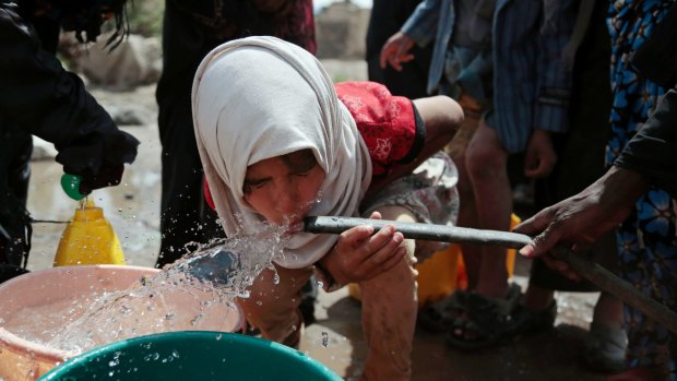 Cholera is usually spread in water: a girl drinks water from a well on the outskirts of Sanaa, in Yemen.