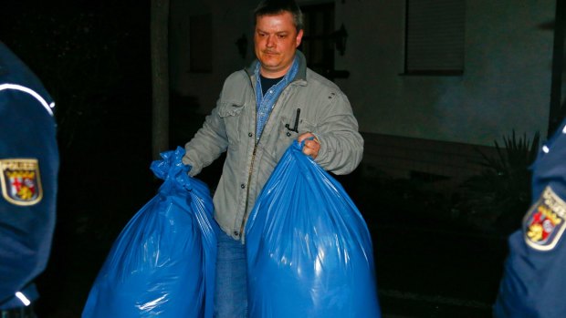 German police officers carry bags of evidence out of a house in Montabaur that belongs to the parents of crashed Germanwings co-pilot Andreas Lubitz. 