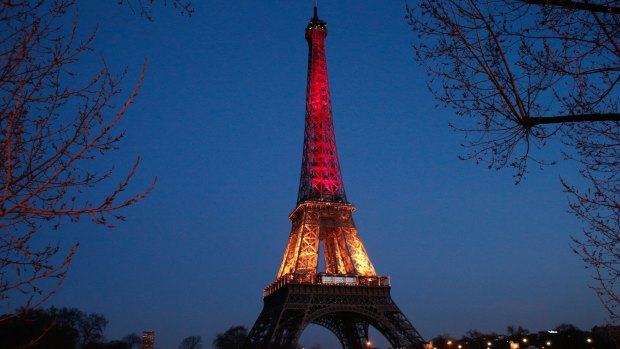 The Eiffel tower illuminated with the Belgium national colours black, yellow and red.