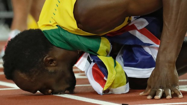 Usain Bolt kisses the track.