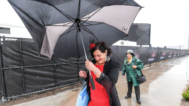 Wet conditions greet race fans arriving at Flemington.