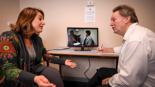 Speech pathologist Helen Tzanakis and Detective Sergeant Tony Breen monitor an interview taking place in the next room. 