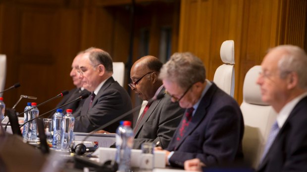 Thomas Mensah, centre, president of the five judge tribunal ruling on the arbitration case between the Philippines and China in the South China Sea.