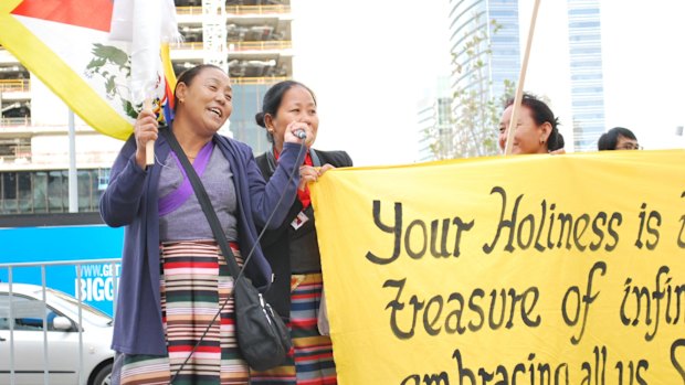 Supporters sang and played instruments while holding signs wishing His Holiness a long life.