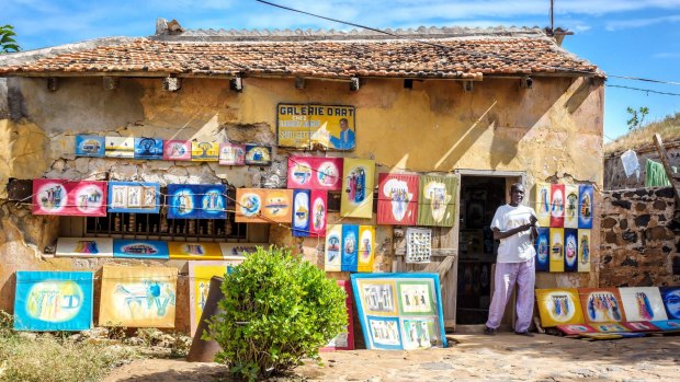 A Senegalese artist sells his paintings on the streets of Gorée Island, Dakar.