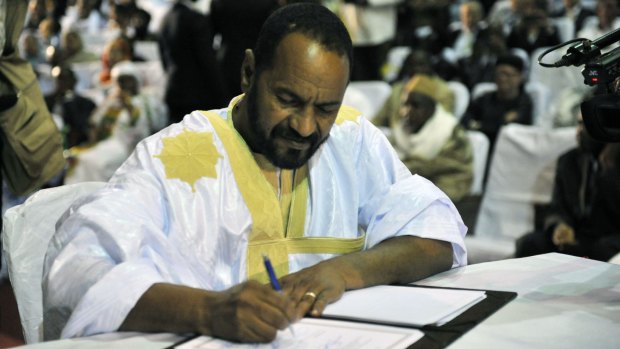 Sidi Brahim Ould Sidati, a member of the rebel alliance, signs the amended peace accord  in Bamako. 