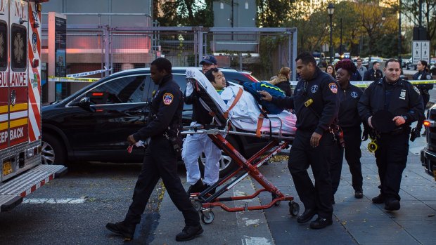 Emergency personnel carry a man into an ambulance after the New York attack on Tuesday.