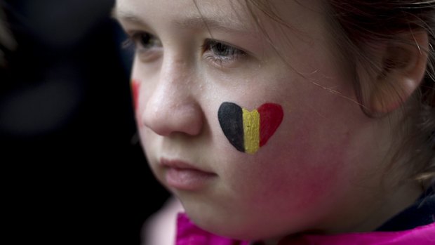 A child looks on during a vigil for the victims of the Brussels attacks at the Belgium Consulate in Montreal, Canada, on Wednesday.