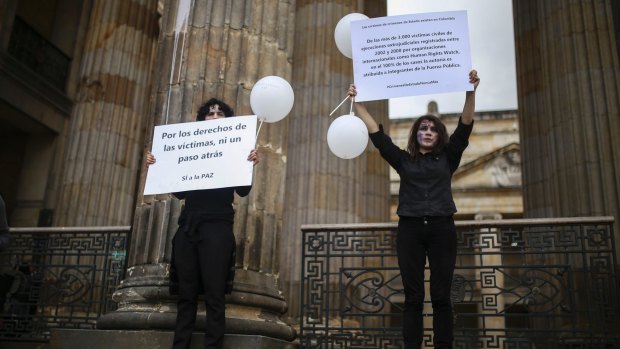 Supporters of peace agreement gather outside the congress in Bogota, Colombia, on Wednesday.