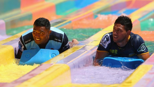 Sliding in: Wycliff Palu and Brumbies star Christian Lealiifano during the 2016 Super Rugby Australian season launch at Wet'n'Wild.
