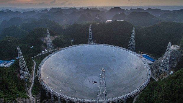 The sun sets above the Aperture Spherical Telescope in Pingtang County in southwestern China's Guizhou Province last week.