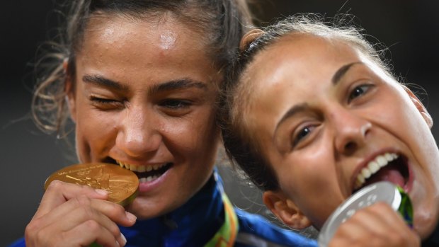 Gold medalist Majlinda Kelmendi of Kosovo and silver medalist Odette Giuffrida of Italy pose on the podium during the medal ceremony for the Women's -52kg Judo on Day 2 of Rio 2016.