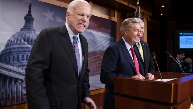 John McCain jokes around as he and Lindsey Graham and Ron Johnson speak to reporters about the opposition to the Republican party's first attempt to replace and repeal ObamaCare.
