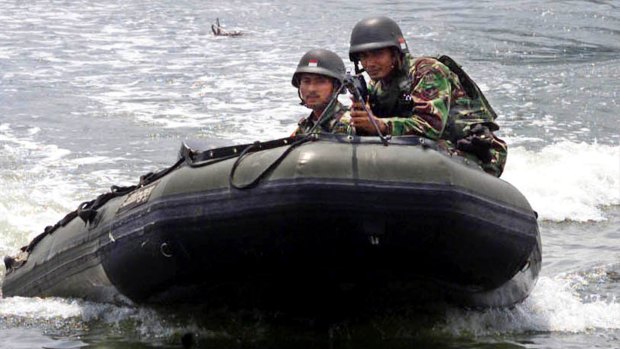 Indonesian soldiers patrol on a rubber boat in Biruen, Aceh province.