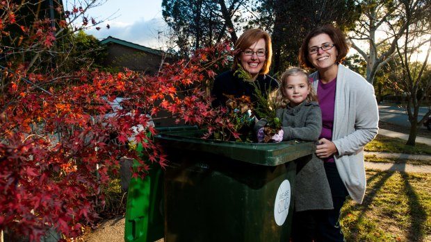 Minister Meegan Fitzharris, left, with Weston Creek residents Cath Collins and her daughter Sammi, after the announcement of a pilot green-waste bin.