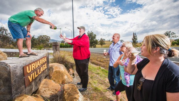 From left, Uriarra residents Aaron Agnew, Rod Sloan, Michael Friedrich, Janice Watt with Evie, 8, and Jess Agnew celebrate an announcement that a solar farm will not be build near their town.