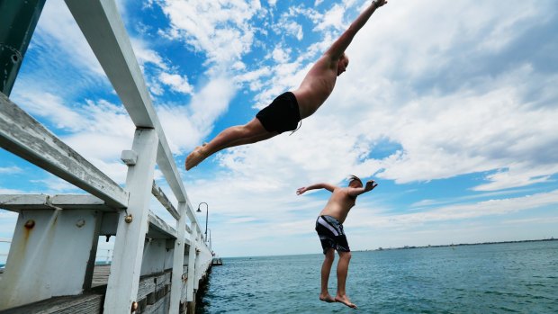 Swedish backpackers Robin Hoghelm and Pontus Nordgren diving off Kerferd Road Pier.