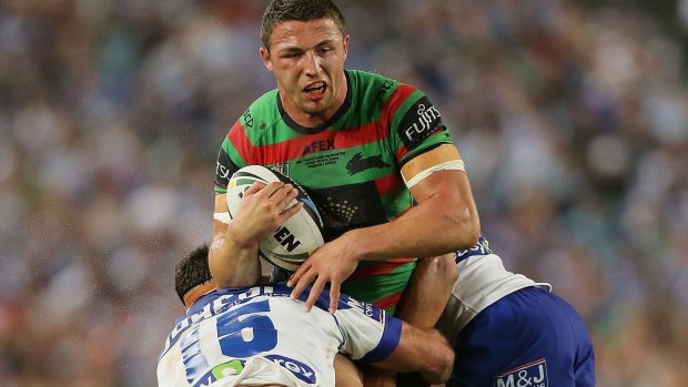 Tough nut: Sam Burgess hits the ball up with a fractured cheekbone in last year's NRL grand final.