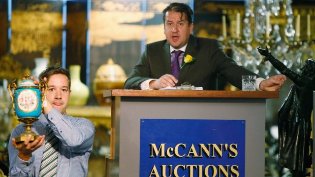 Auctioneer Christian McCann with one of  a  pair of 19th century Sevres and ormolu vases which sold for  $8250.