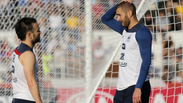 Co-operating: Mathieu Valbuena, left, and Karim Benzema, right, chat during a France national team training session. 