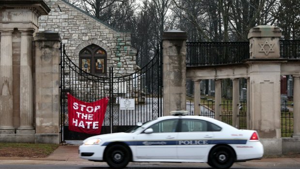 A University City police car patrols in front of Chesed Shel Emeth Cemetery in University City, Missouri, last month.