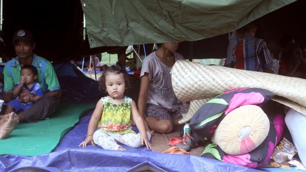 A family rests in a tent at an evacuee camp in Klungkung, Bali, Indonesia.