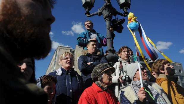 A woman holds up a yellow duck toy during protests in downtown Moscow on the weekend. 