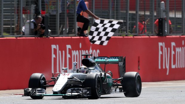 Chequered flag: Mercedes driver Lewis Hamilton crosses the finish line to win.